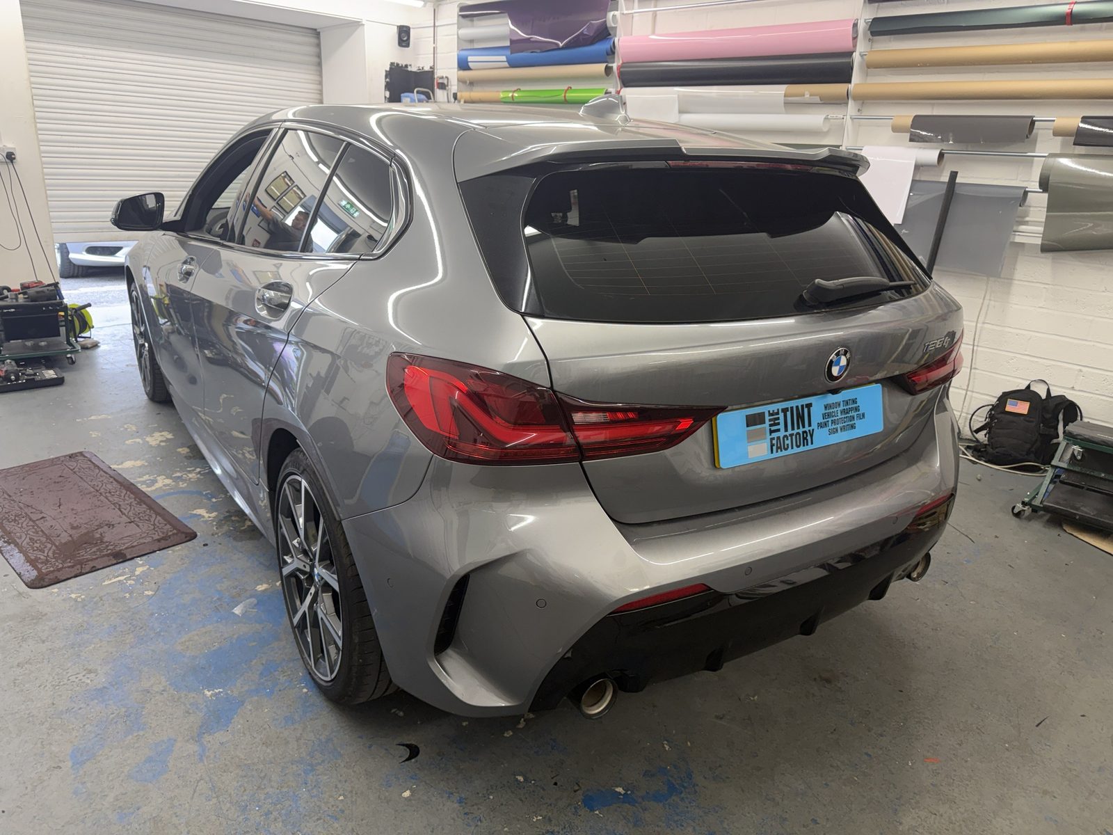 Grey BMW 1 Series M Sport with tinted rear windows in the workshop