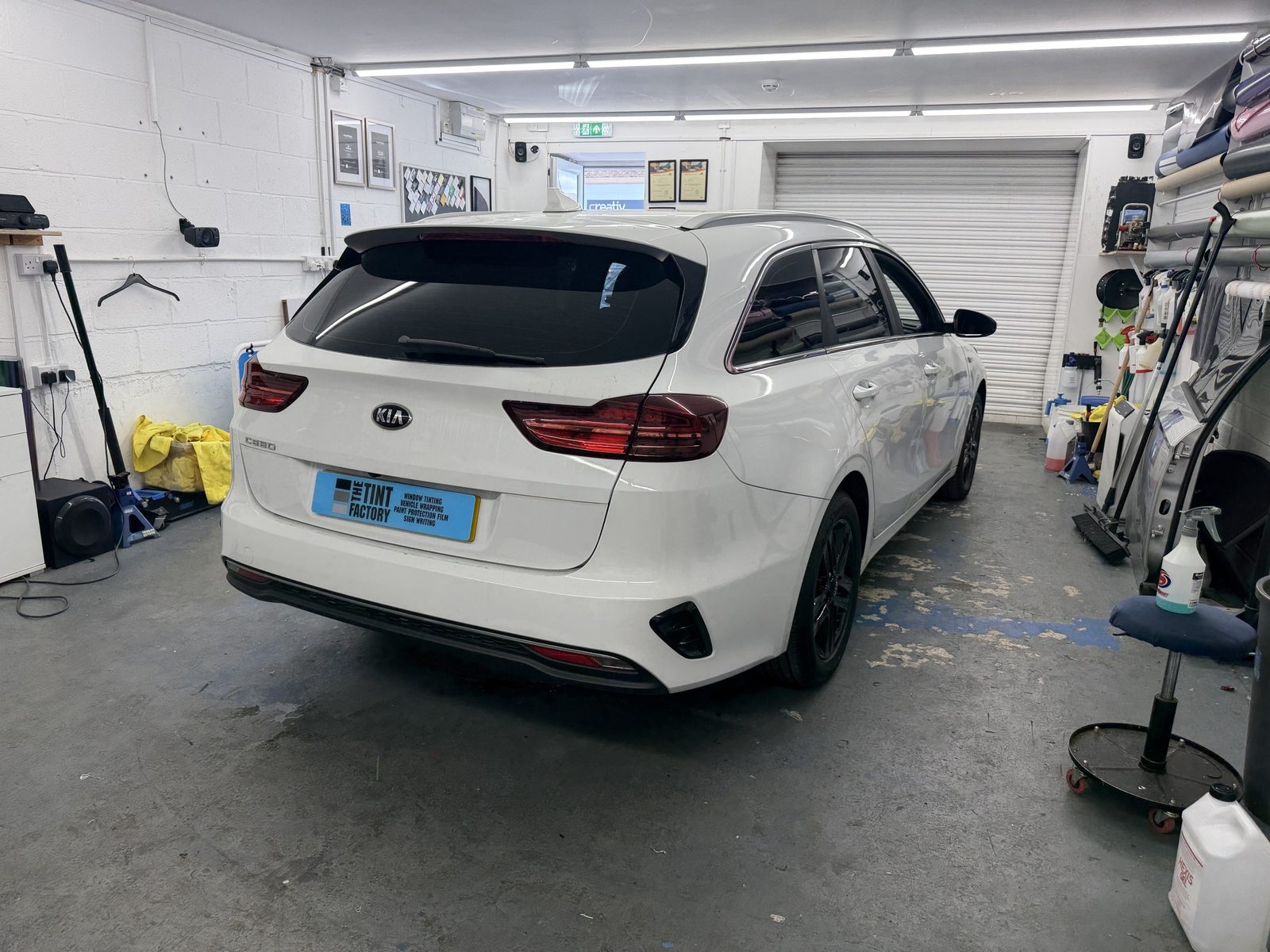 White Kia Ceed Sportswagon with tinted rear windows in the workshop