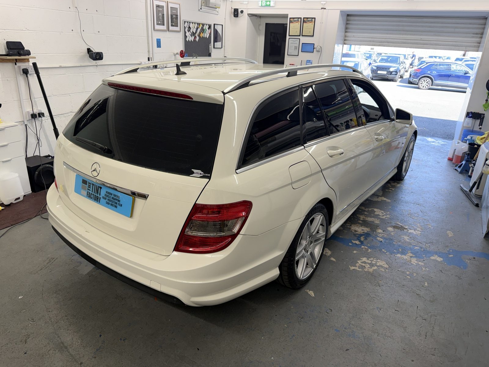 White Mercedes C-Class estate with tinted rear windows, the family and dog car, in the workshop
