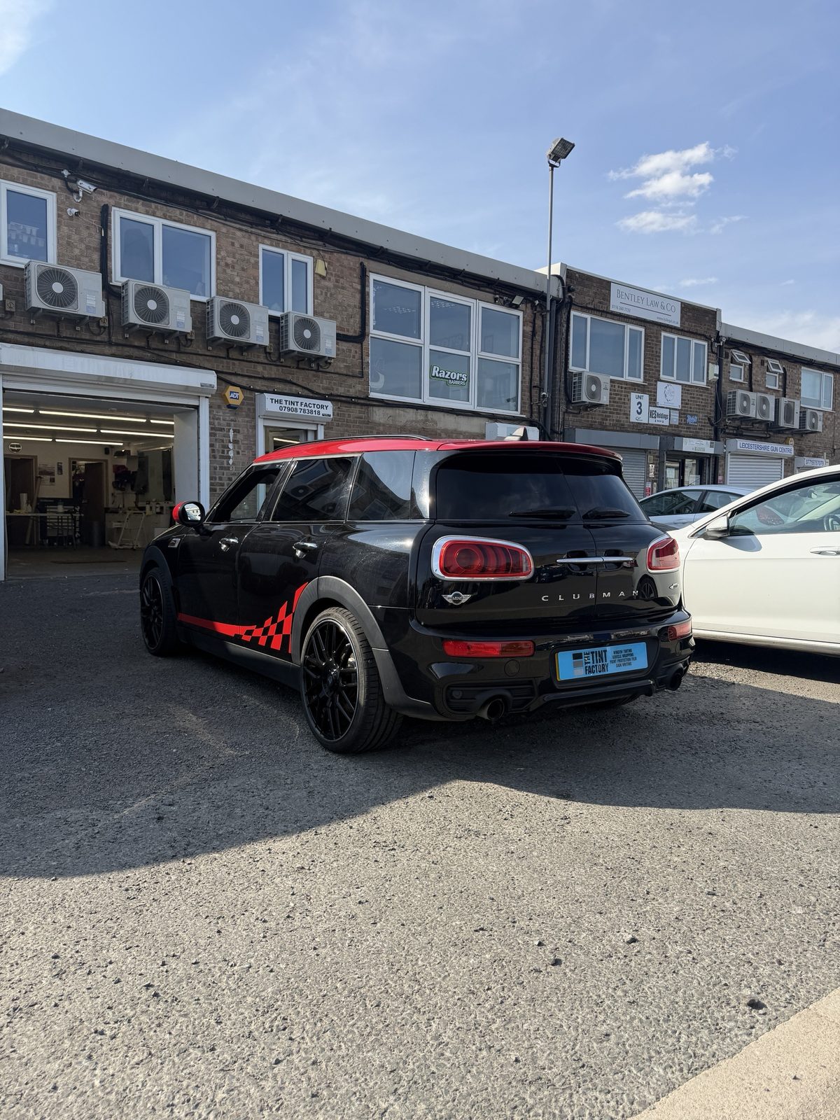 Black and red Mini Clubman JCW with tinted rear glass outside The Tint Factory, Unit 3 Branstons Industrial Estate